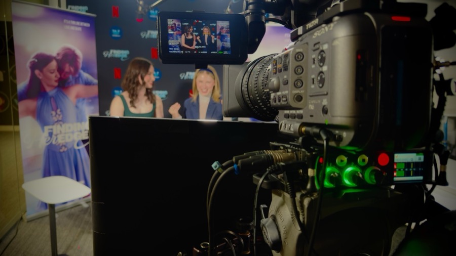 Camera operator monitoring a junket interview on a Sony cinema camera rig